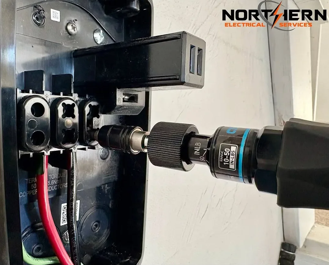 Tesla Wall Connector being torqued with a torque wrench
